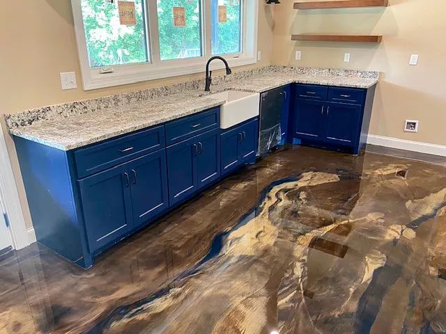 Blue kitchen cabinets with granite countertops and a glossy brown-black floor finish