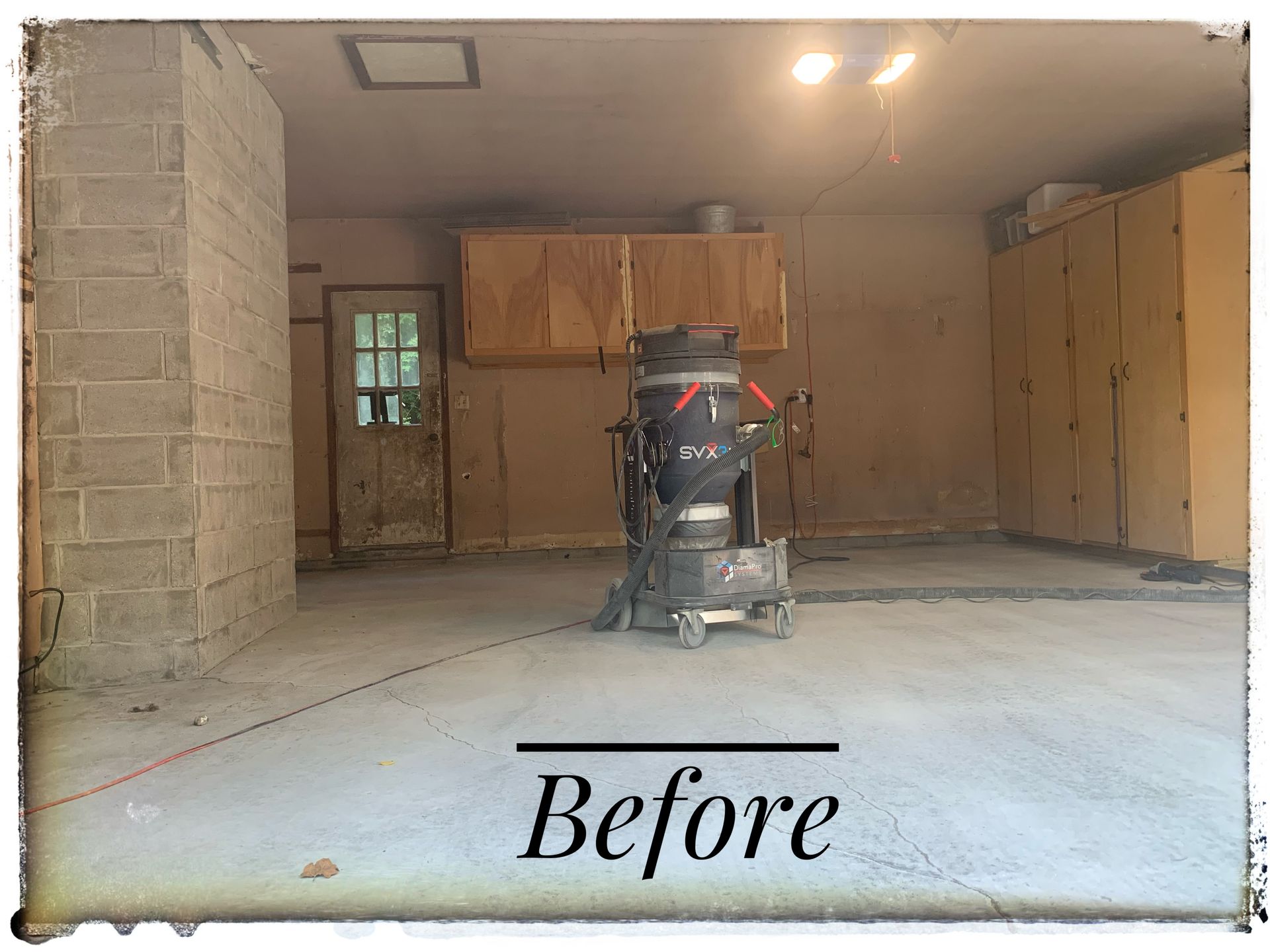 Basement room before renovation, with a vacuum in the center and the word “Before” at the bottom