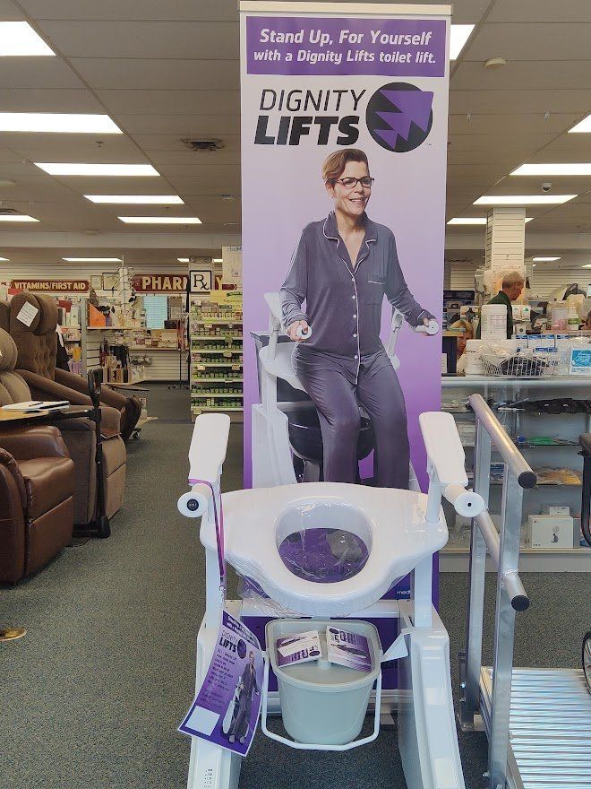 An indoor store displays a Dignity Lifts product with a banner showing a woman using it.