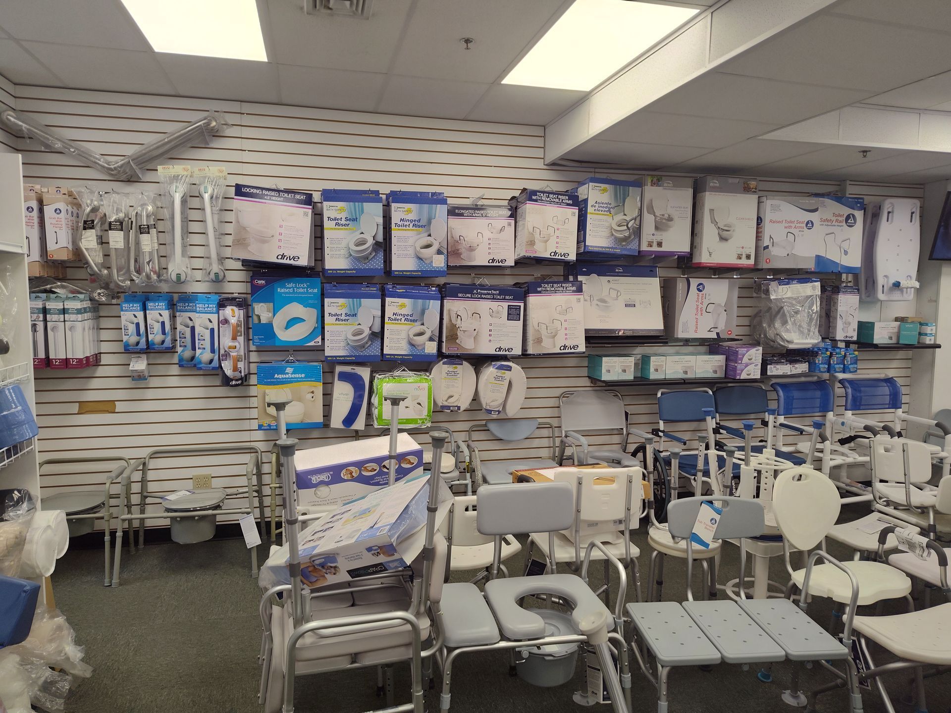 Medical supply store aisle with mobility aids and incontinence products on display.