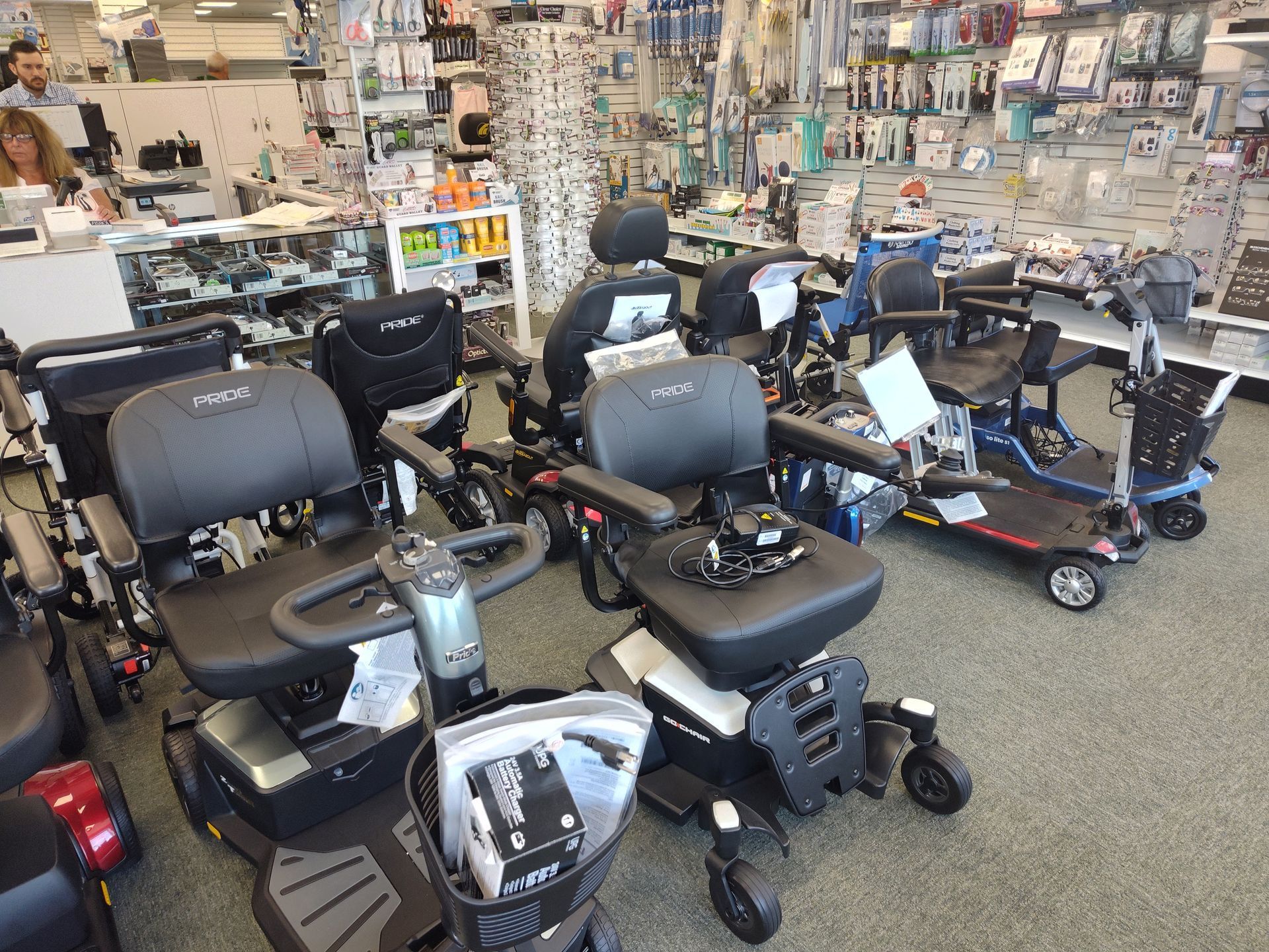Mobility scooters displayed in a store, with various models and accessories.
