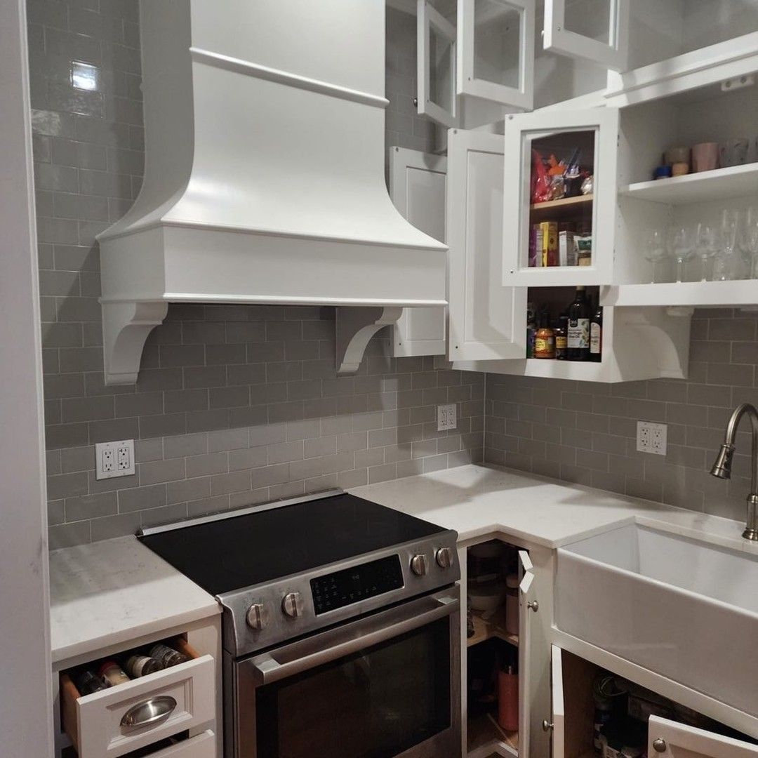 a kitchen with a stovetop oven and a sink