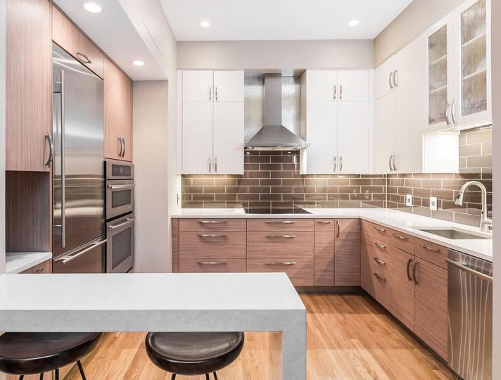 a kitchen with stainless steel appliances and wooden cabinets