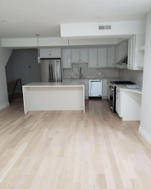 an empty kitchen with a large island in the middle of the room
