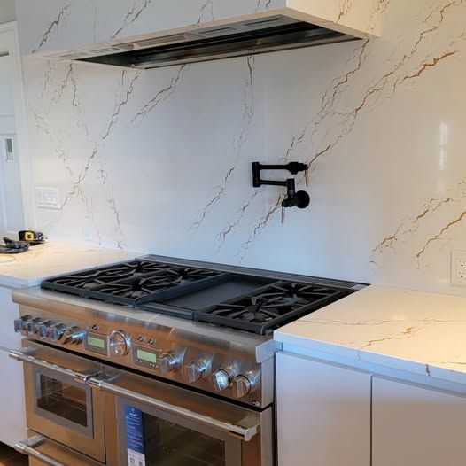 a kitchen with a stovetop oven and a sink