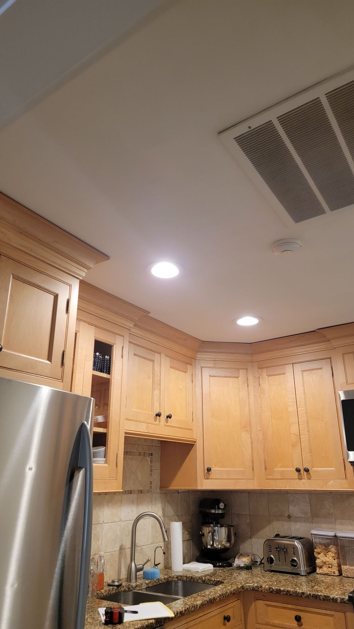 a well-lit kitchen with wooden cabinets