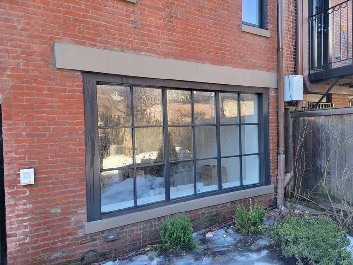 a large window on the side of a brick building