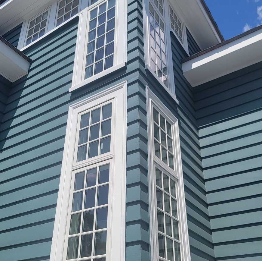 a blue house with white windows