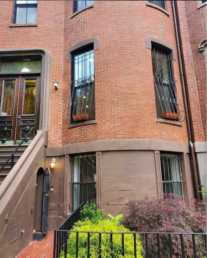 a brick building with stairs leading up to the front door