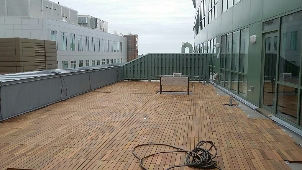 a wooden deck is being built on the roof of a building