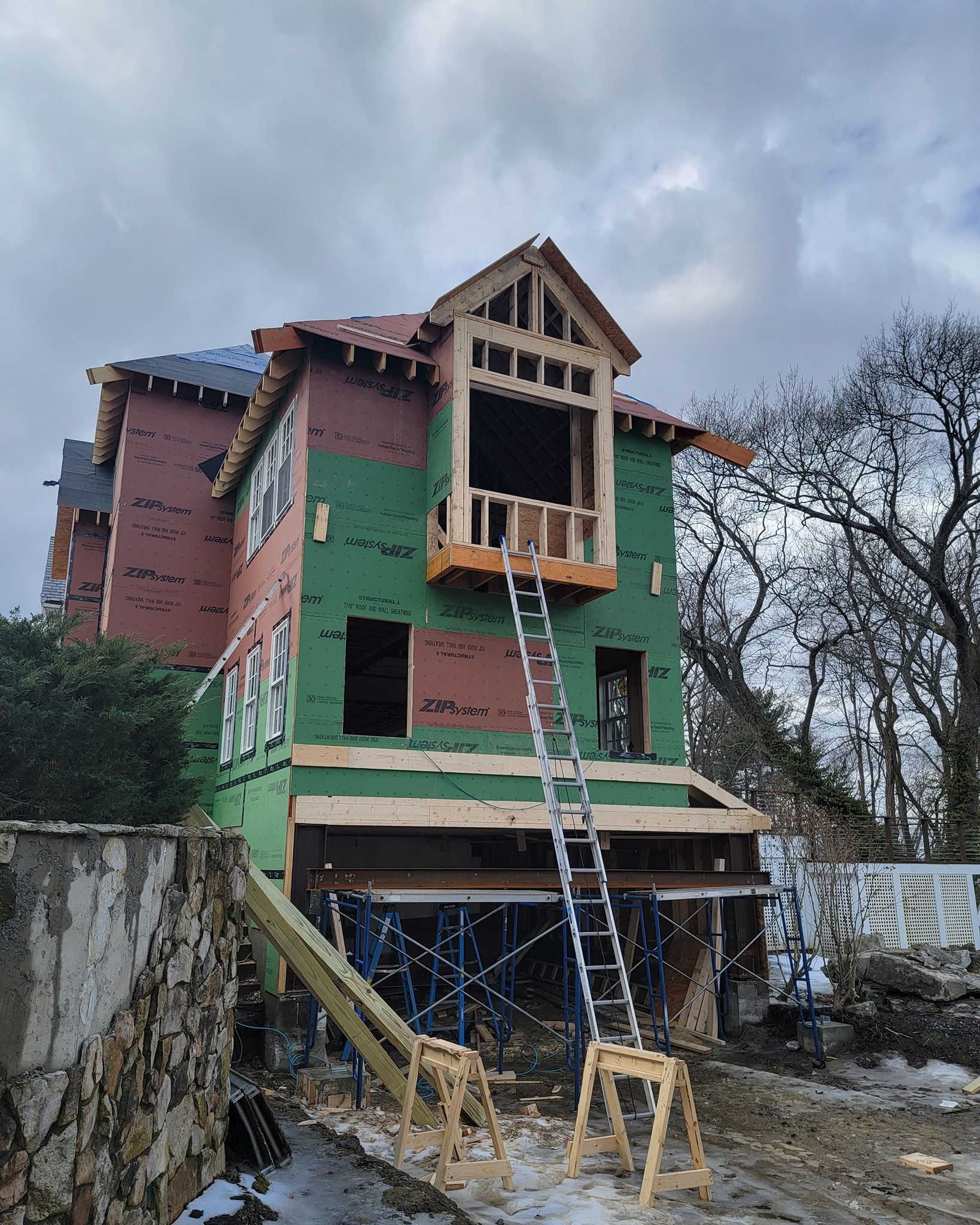 a house is being built with a ladder in  front of it