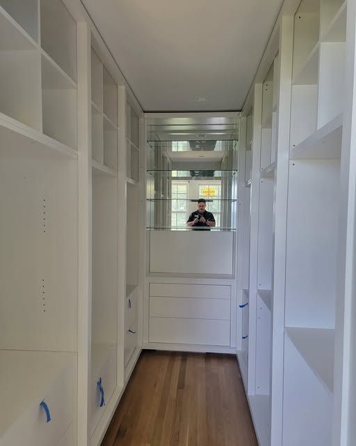 a walk-in closet with a mirror