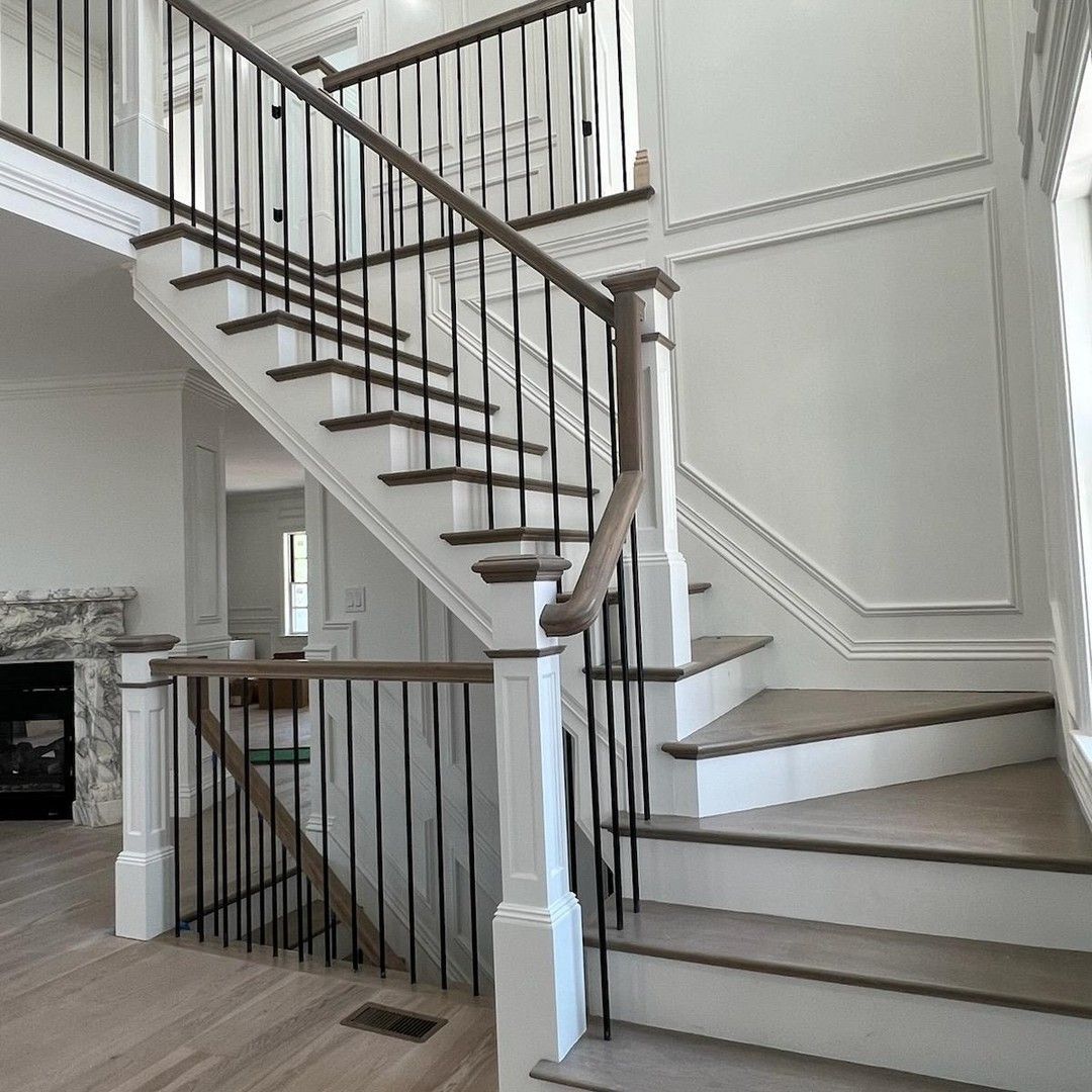 a staircase with wooden steps and a metal railing in a house