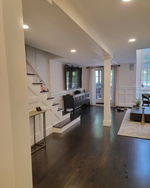 a living room with stairs leading up to the second floor