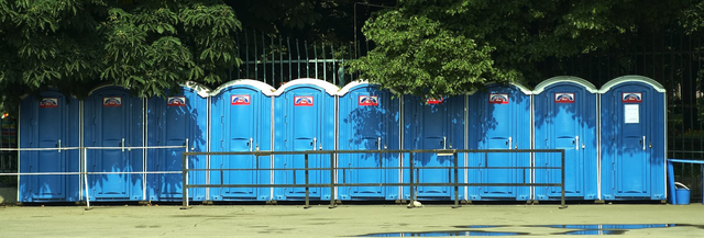blue portable toilets in a line