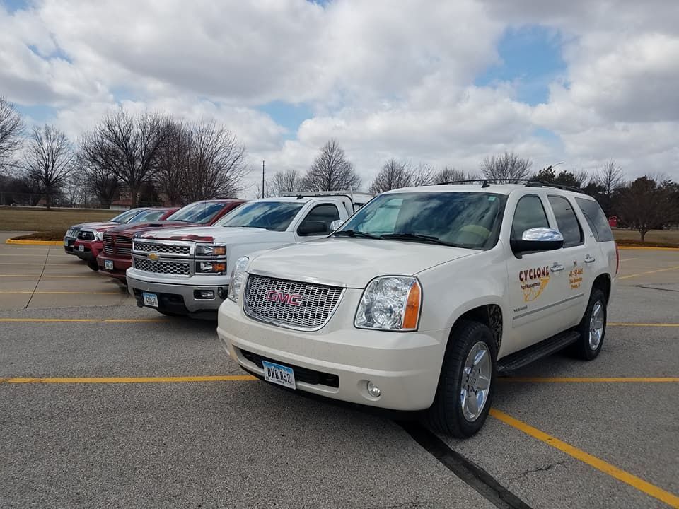 A row of cyclone pest management service vehicle