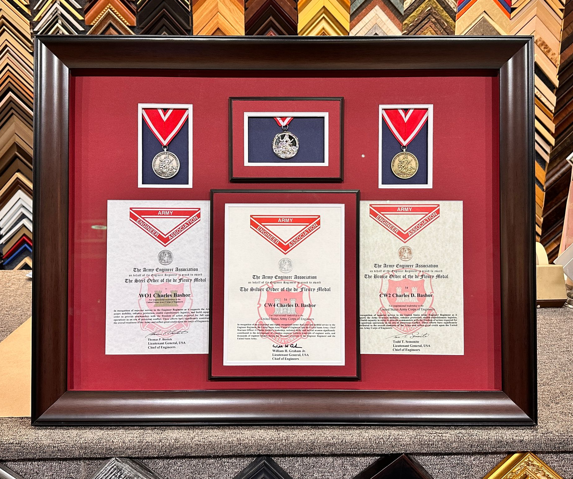 Pile of various colored frame corners, some with gold accents, on sale.