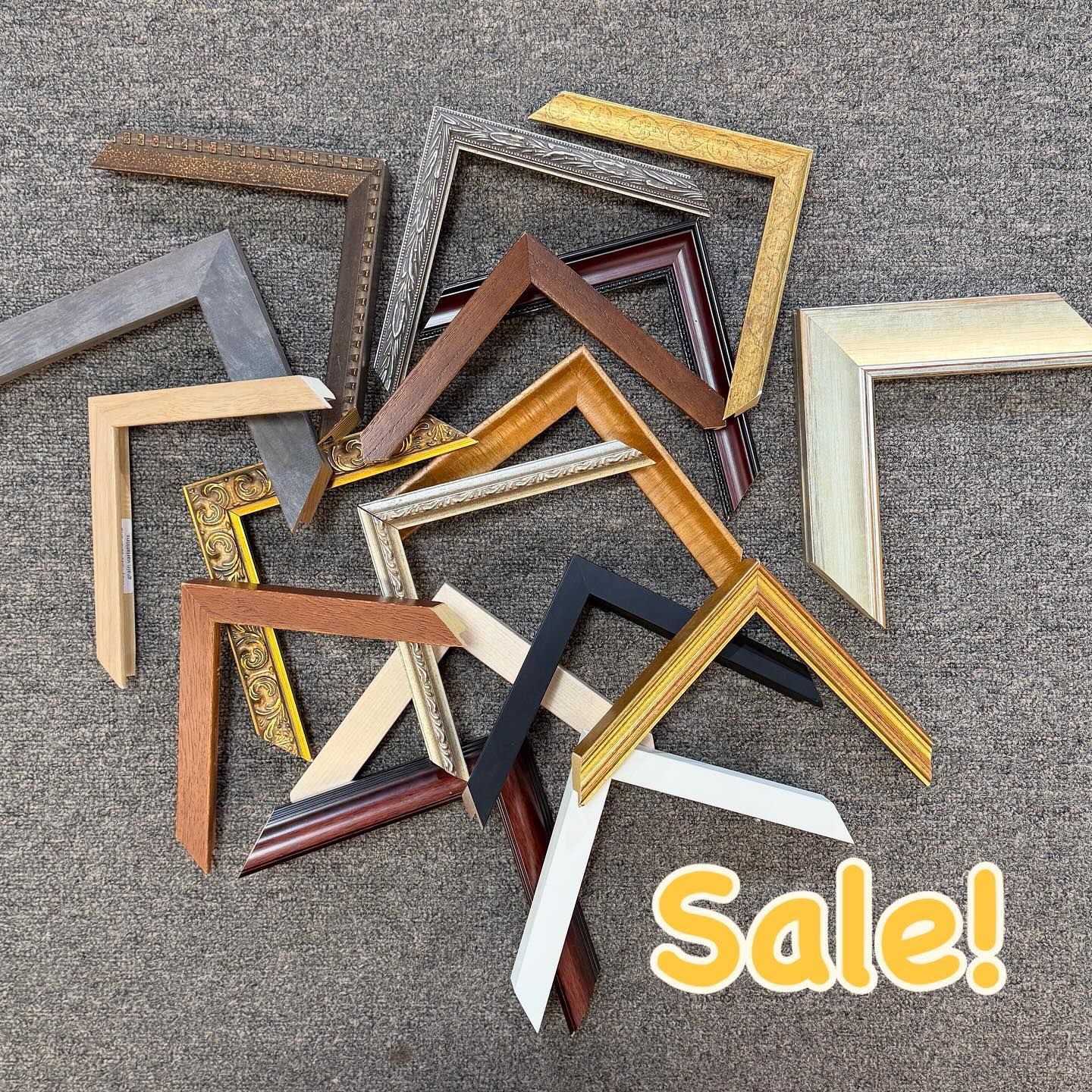 Pile of various colored frame corners, some with gold accents, on sale.