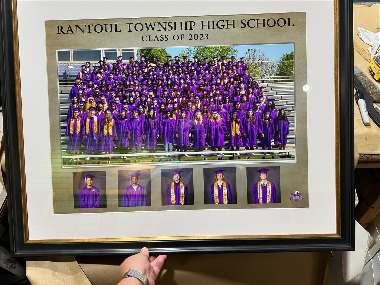 Rantoul Township High School class photo 2021: students in purple gowns, group shot. Gold frame with individual portraits below.