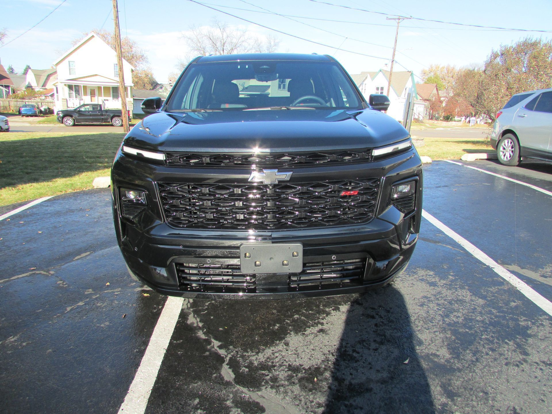 Black Chevrolet Trailblazer SUV, front view, parked in lot, sunny day.
