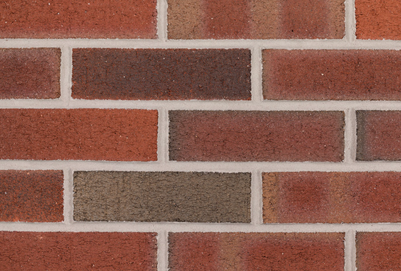 Close-up of a red brick wall with light gray mortar lines