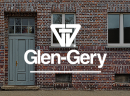 Glen-Gery logo on a brick building facade with windows and a gray door