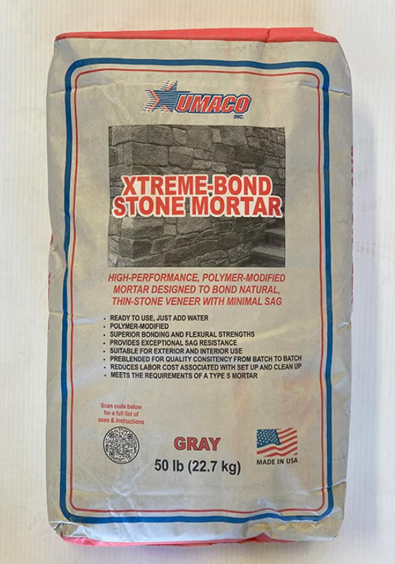 Bag of gray XTREME BOND stone mortar, 50 lb, with red and blue labeling