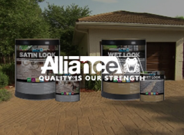 Alliance Quality Is Our Strength banner with paint buckets labeled Satin Look and Wet Look on a wooden deck outdoors