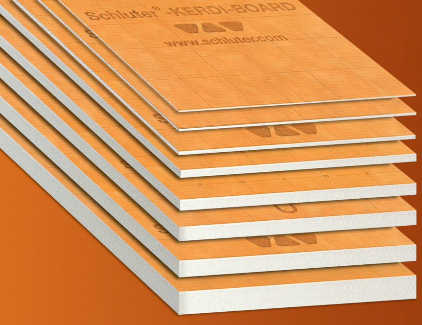 Stack of orange foam insulation boards with white edges, shown in layers against an orange background