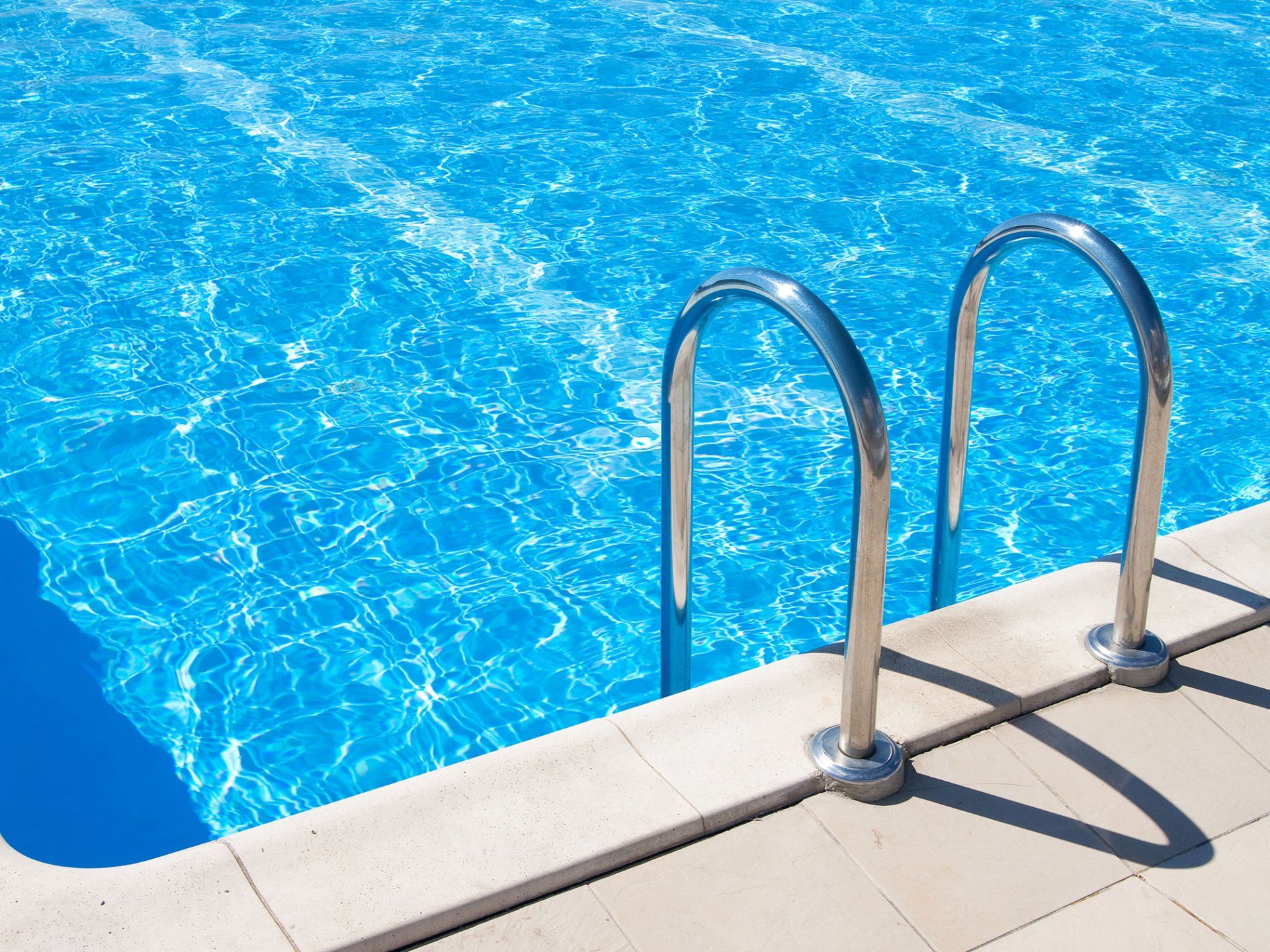 A swimming pool with stairs leading up to it
