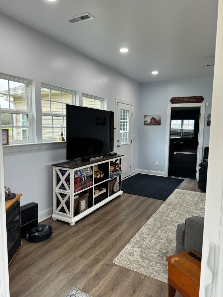 A living room with a flat screen tv on a stand.
