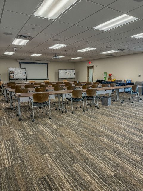 A large room with tables and chairs in it