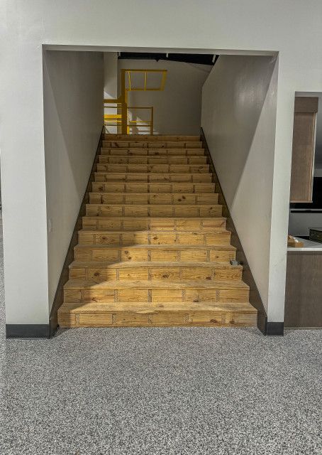 A set of wooden stairs leading up to the second floor of a building.