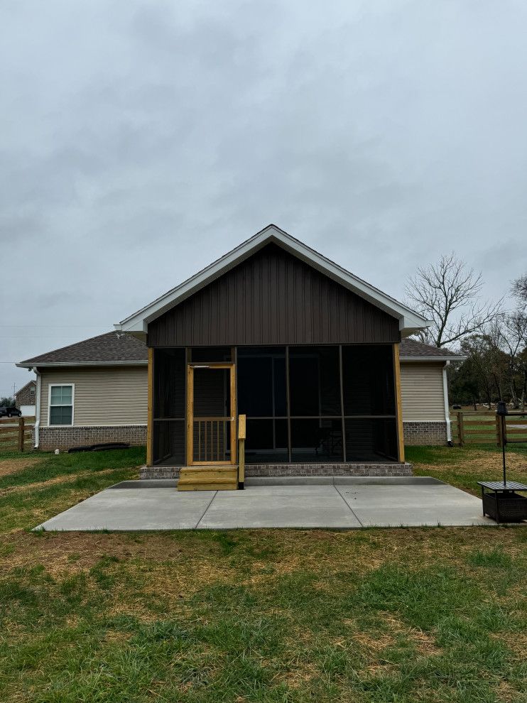 A house with a screened in porch in front of it.