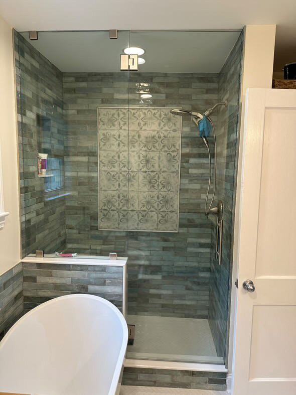 A bathroom with a walk in shower and a bathtub.