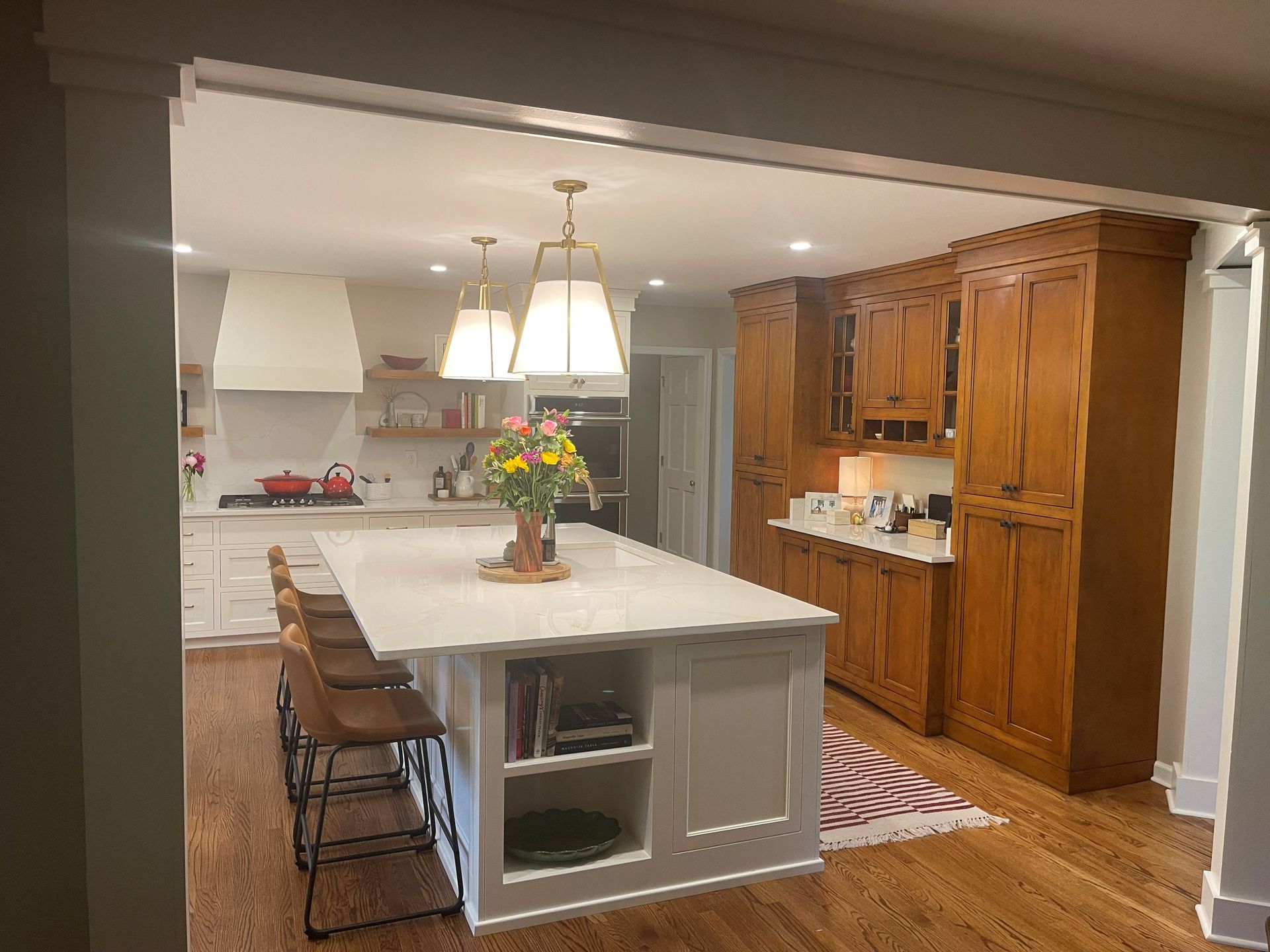 A kitchen with a large island in the middle and wooden cabinets