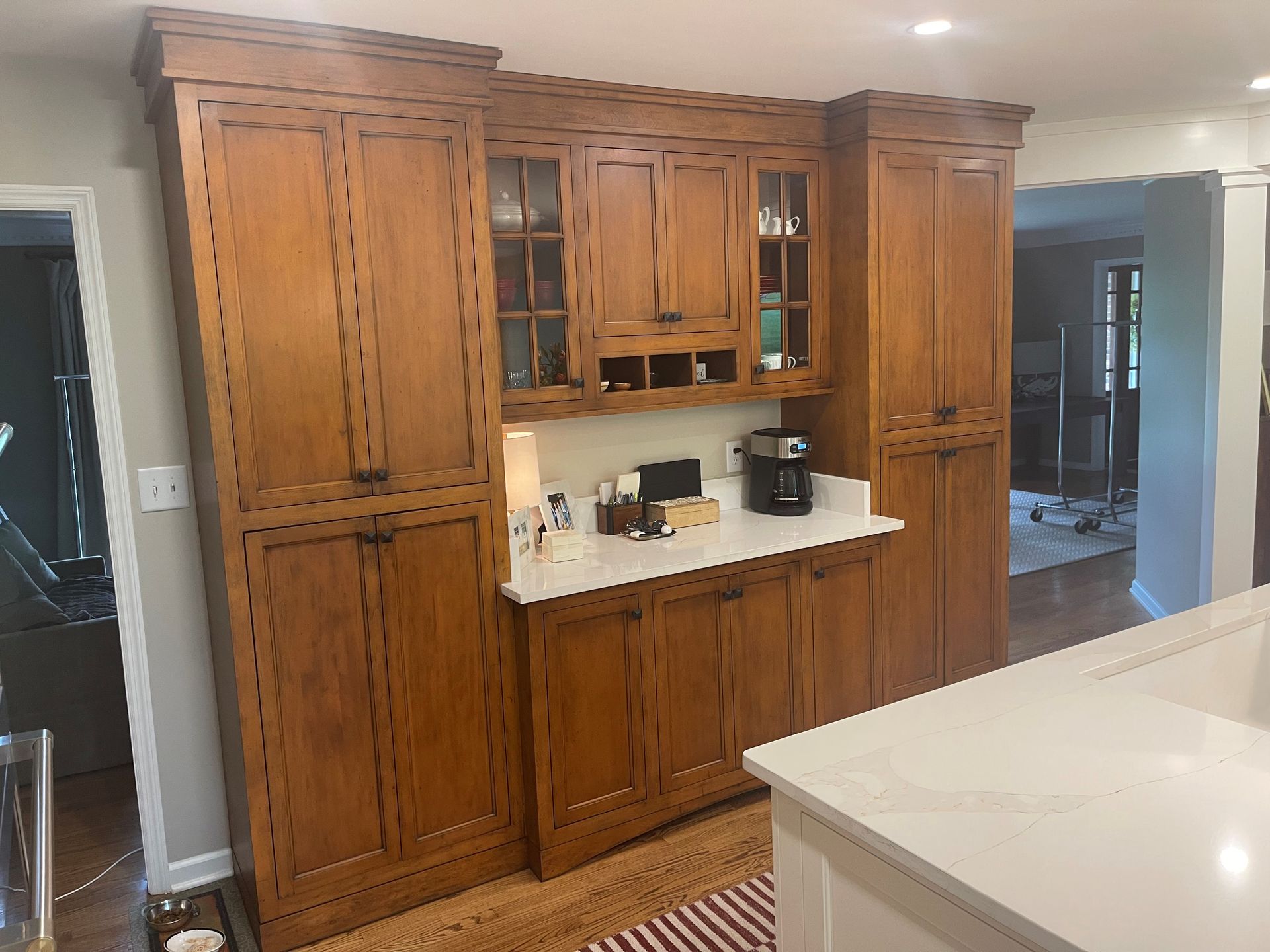 A kitchen with wooden cabinets and a white counter top