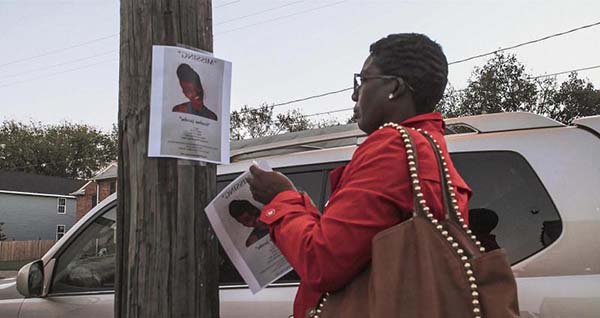 Marginalized Missing Persons Investigations Woman Posting Missing Persons Poster