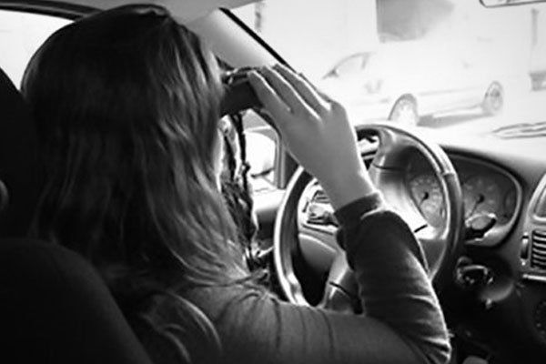 Female Investigator In Car Using Binoculars