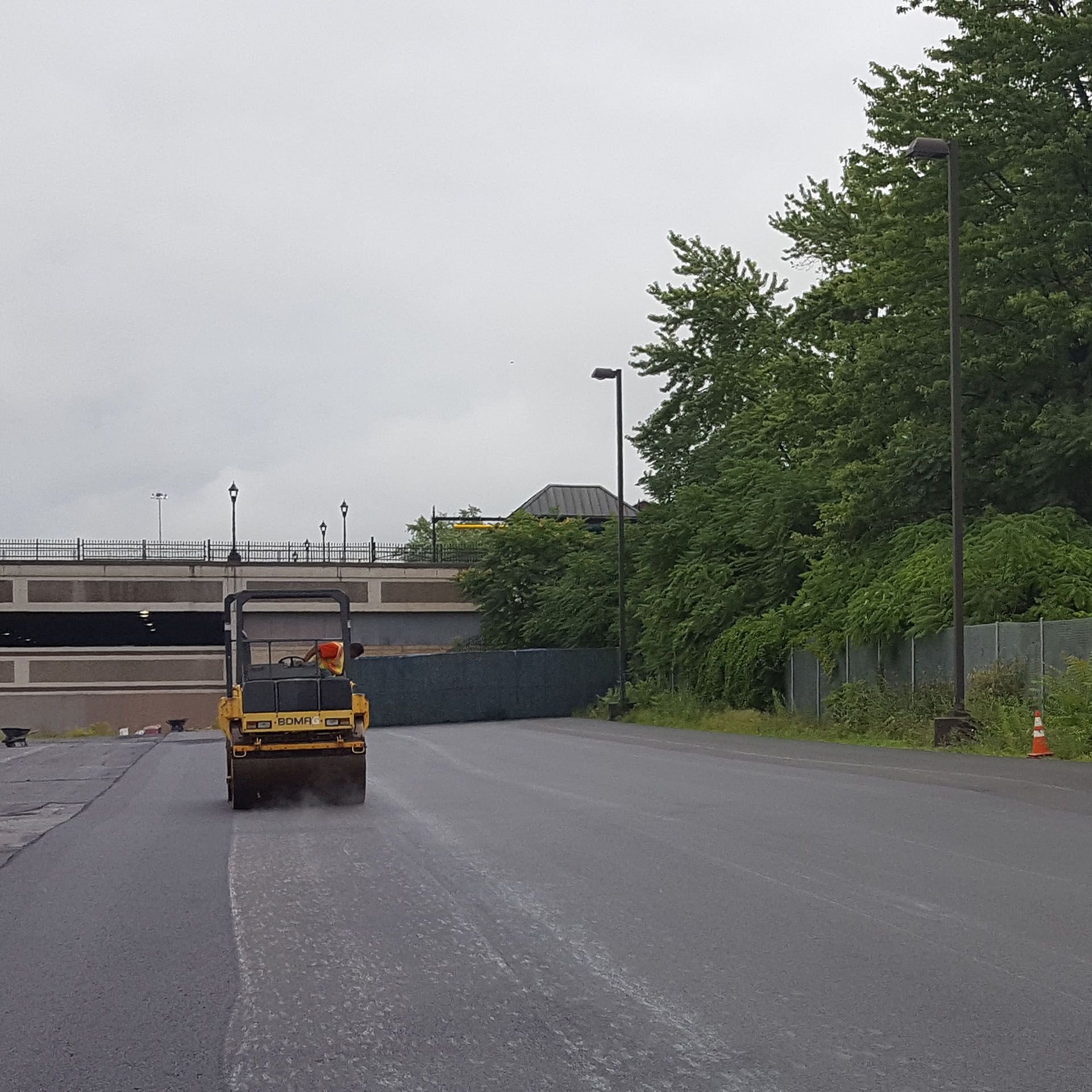 a yellow road roller is paving a road