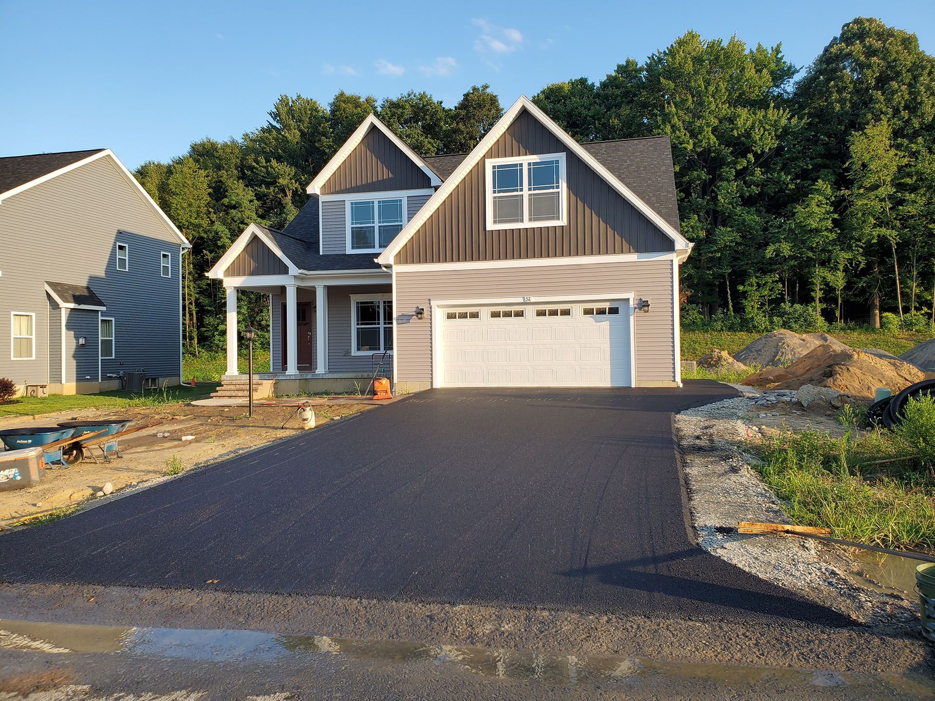 a house with a newly paved driveway