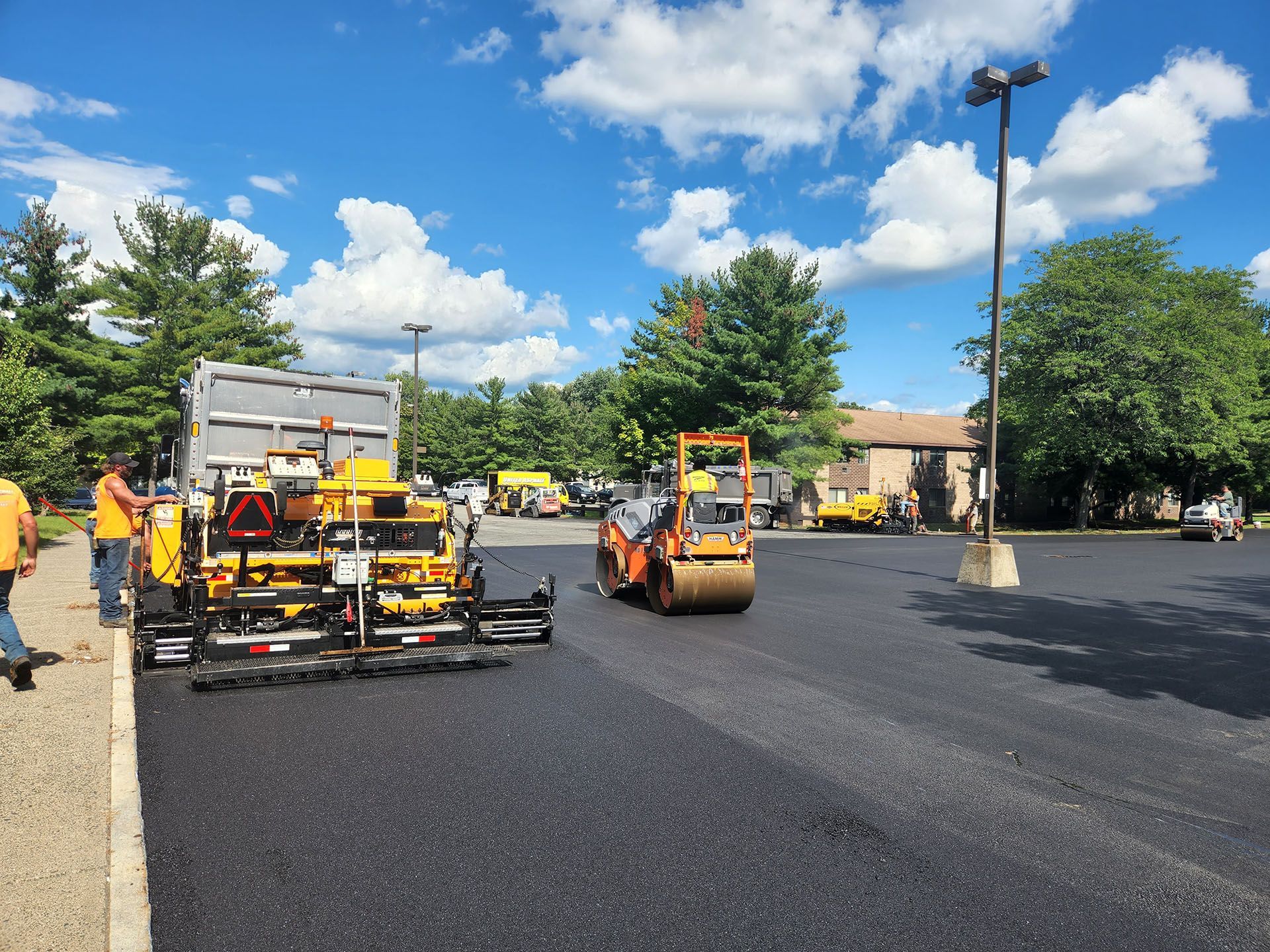 a group of construction vehicles are working on a road