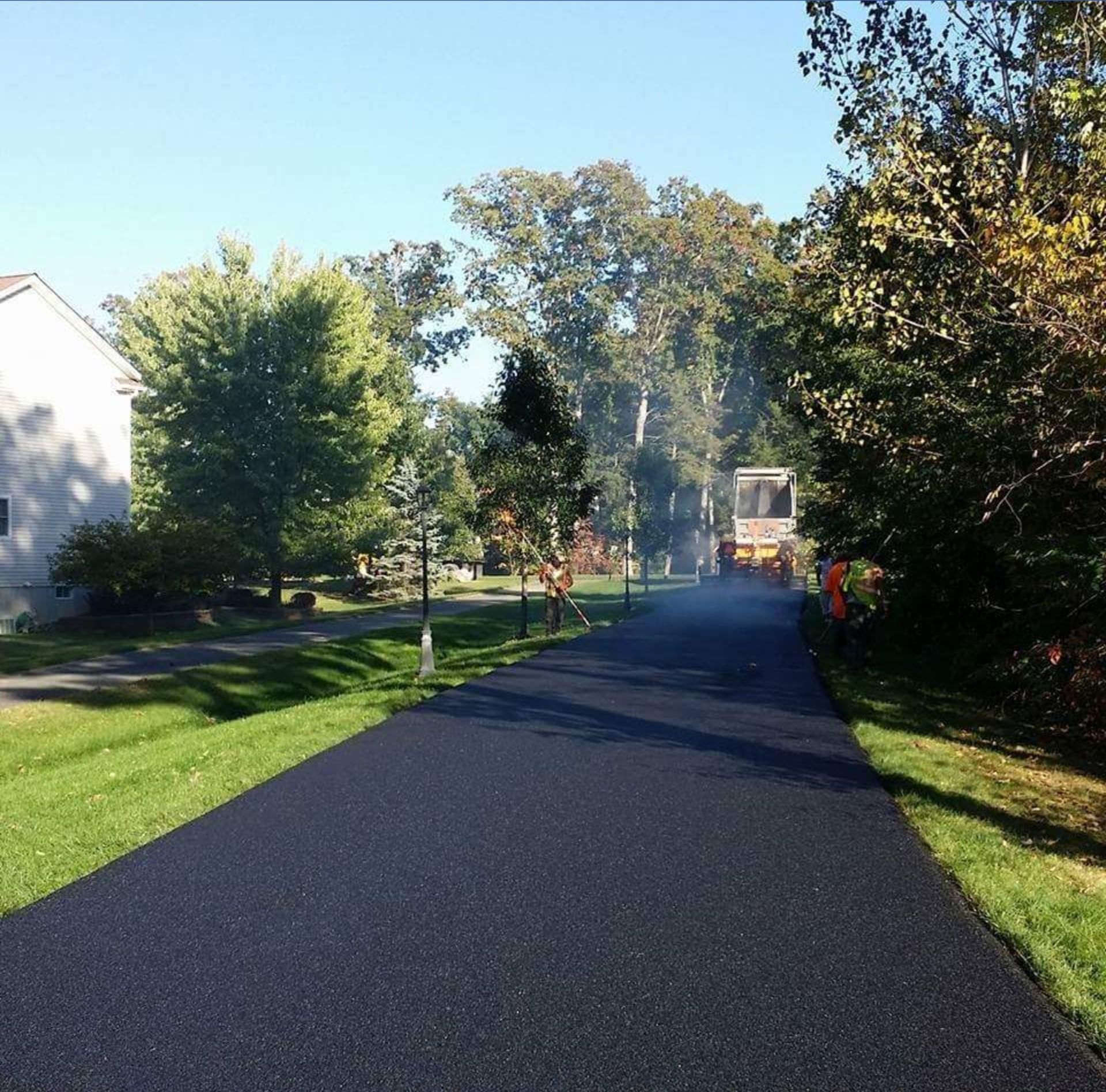 a road that is being paved in a residential area
