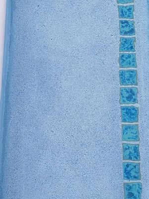 Light blue textile with a vertical row of square, teal-colored tiles.