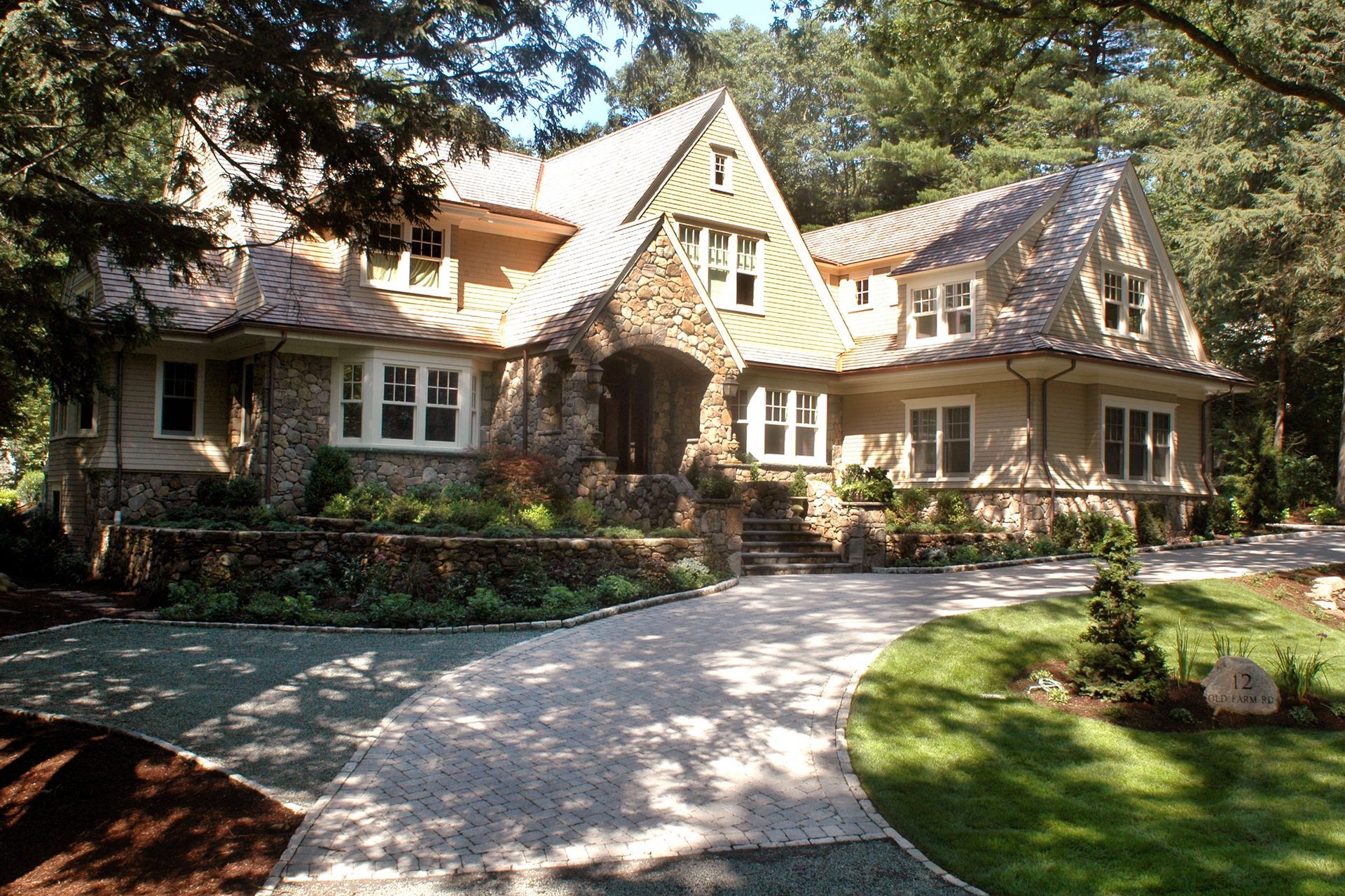 A large house with a gravel driveway in front of it