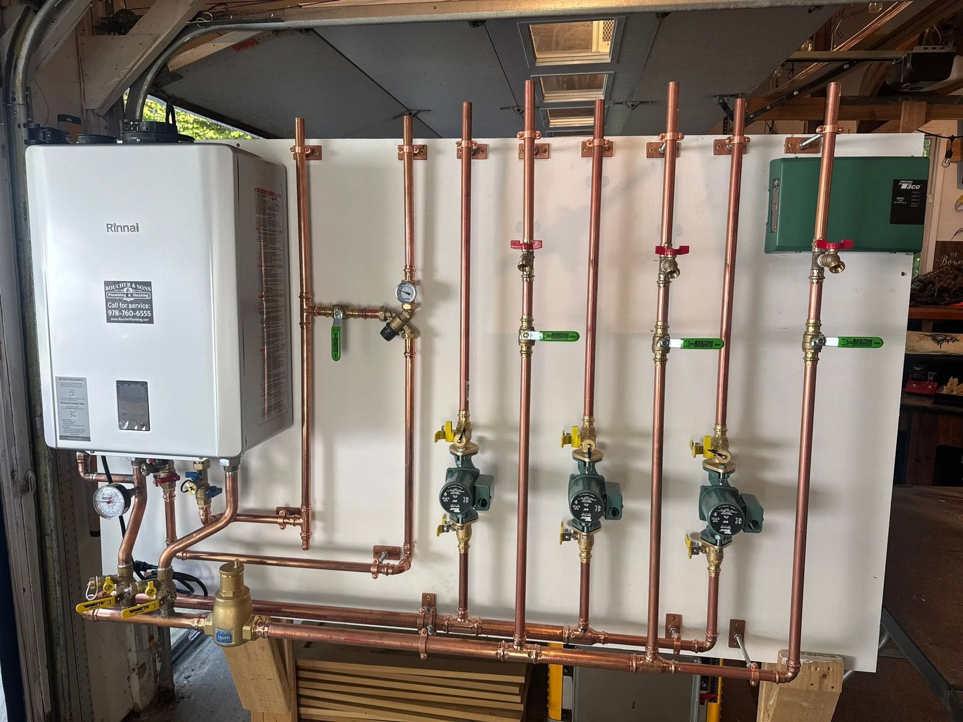 Wall-mounted boiler and copper plumbing pipes in a utility room