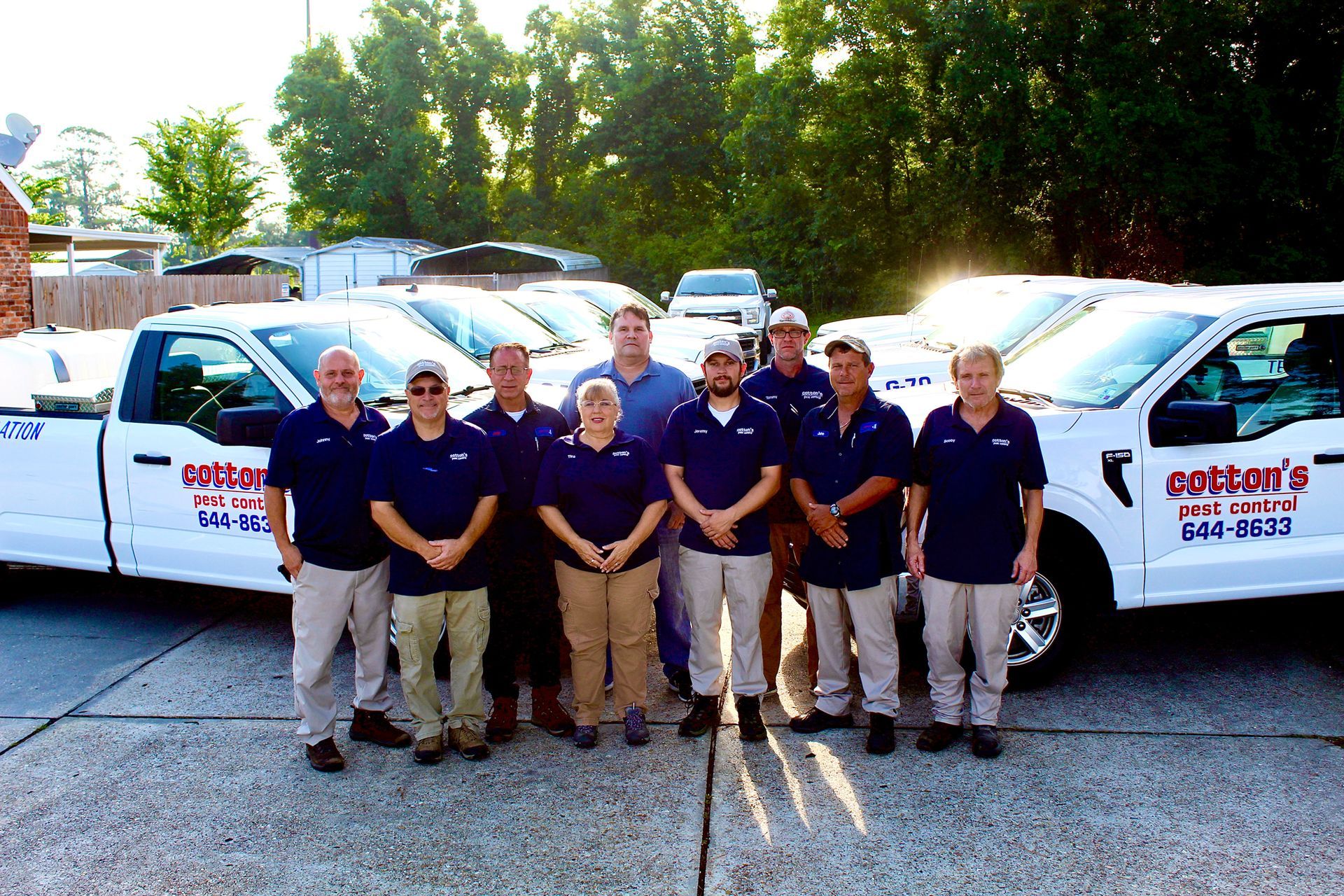 A group of people standing in front of cotton's trucks
