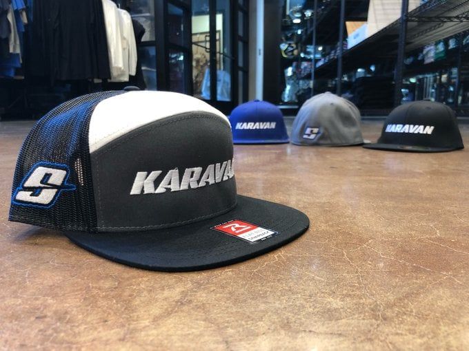 A black and white hat with the word karavan on it