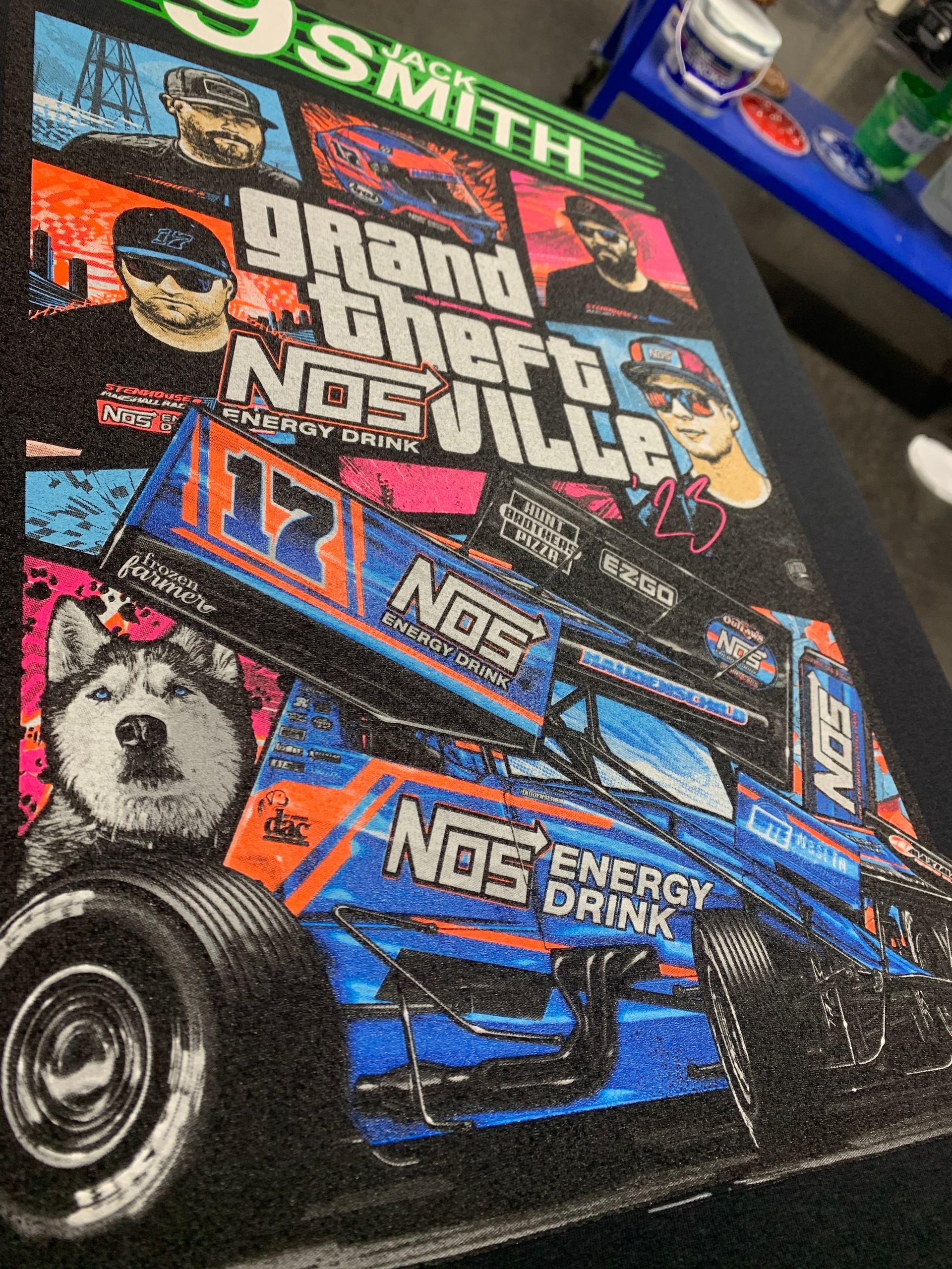 A man wearing a grey sweatshirt and a beanie is making a funny face.