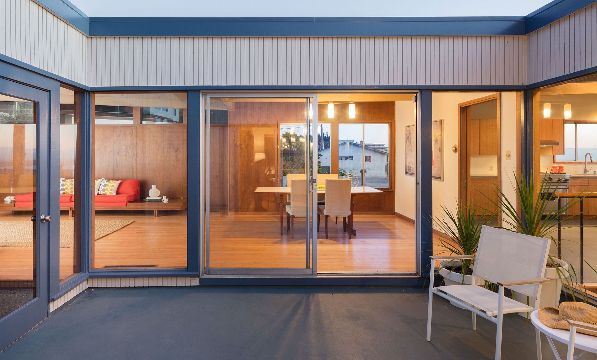 There is a patio in the middle of the house with sliding glass doors leading to the dining room